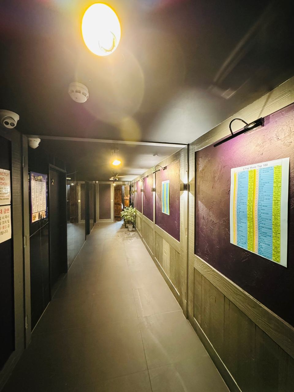 The corridor at HANJAN leading past the doors of the private karaoke rooms